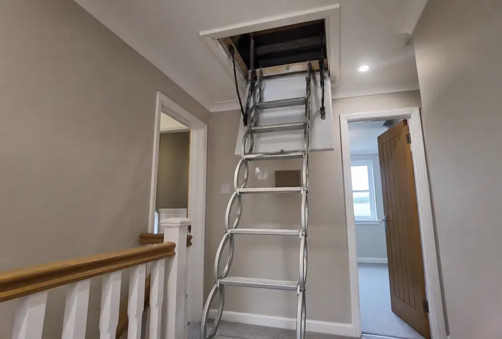 New insulated loft hatch with a concertina loft ladder extended onto the landing